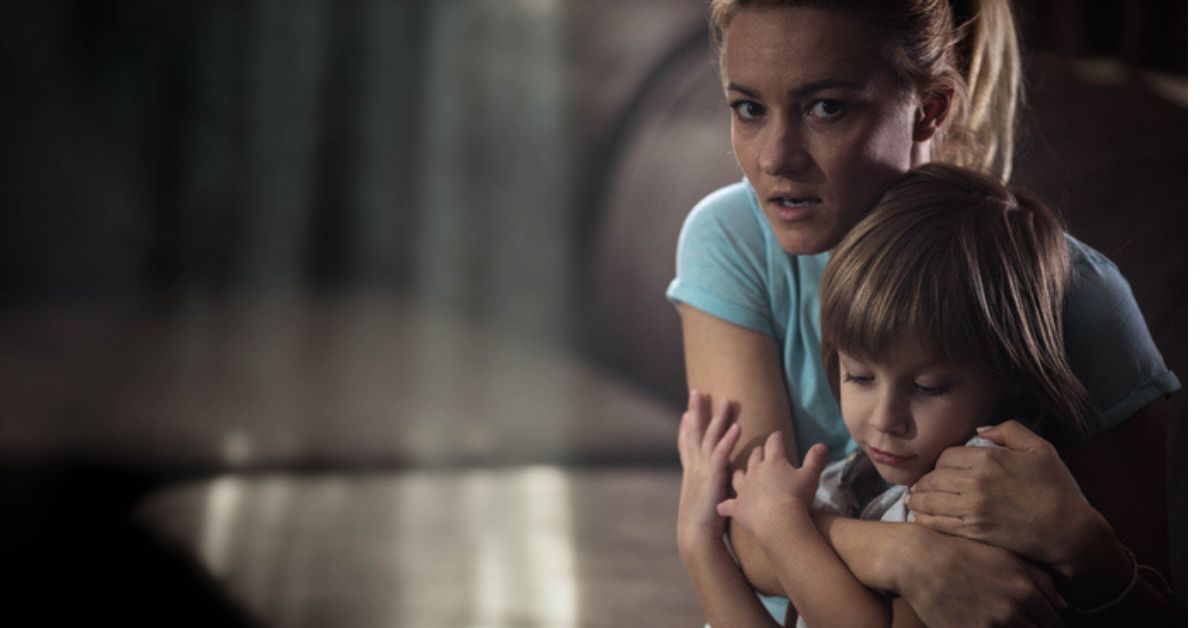 scared woman guarding child