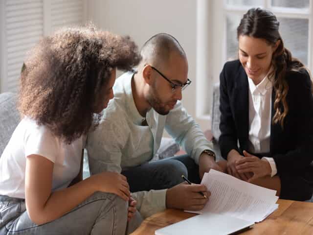 Couple Signing Documents with Attorney