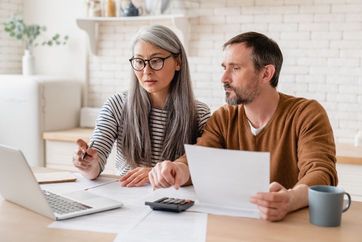 man and forensic accountant reviewing documents