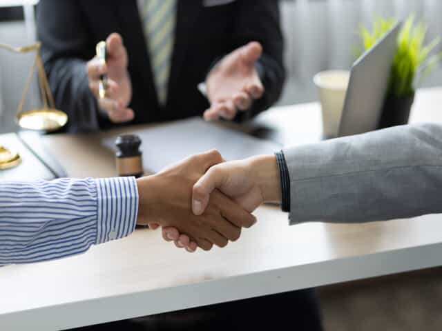 Shaking Hands in Front of Lawyer