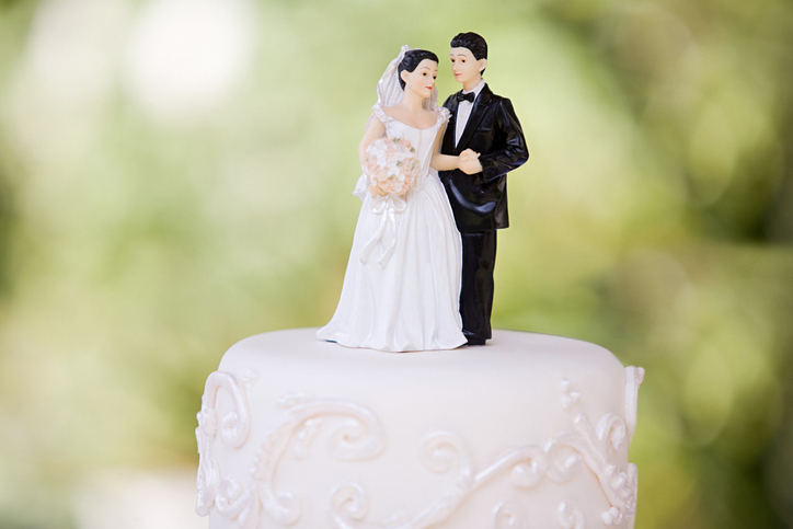 bride and groom cake topper on wedding cake